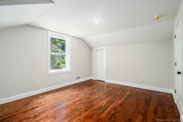 bonus room with wood-type flooring and vaulted ceiling