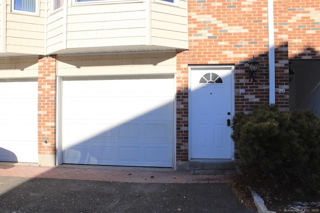 doorway to property featuring a garage