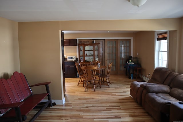 living room featuring light hardwood / wood-style floors and baseboard heating