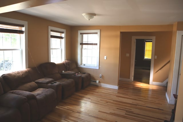 living room featuring baseboard heating and wood-type flooring