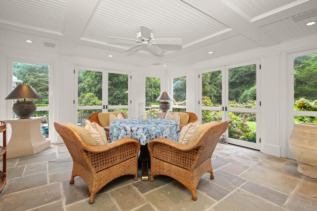 sunroom with coffered ceiling, a wealth of natural light, and french doors