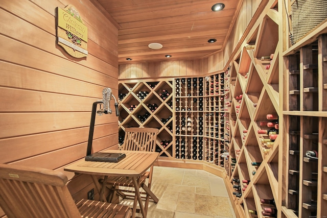 wine cellar featuring wood walls, stone tile flooring, wood ceiling, and recessed lighting