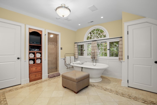 114 Ferris Hill Rd, New Canaan, CT 06840 - bathroom with a stall shower, tile patterned floors, a soaking tub, inlaid floor details, and baseboards