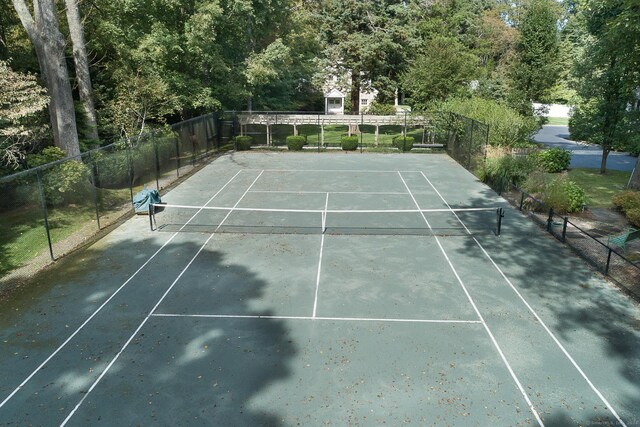 view of sport court featuring fence