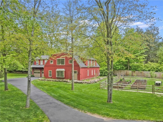 view of side of property with a garage and a lawn