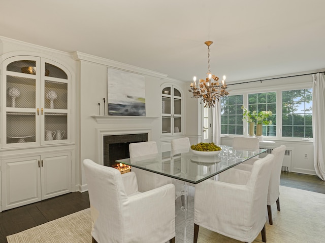 dining space featuring a chandelier, radiator heating unit, and dark hardwood / wood-style floors