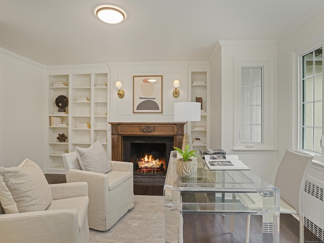 living room featuring hardwood / wood-style flooring, radiator, and ornamental molding