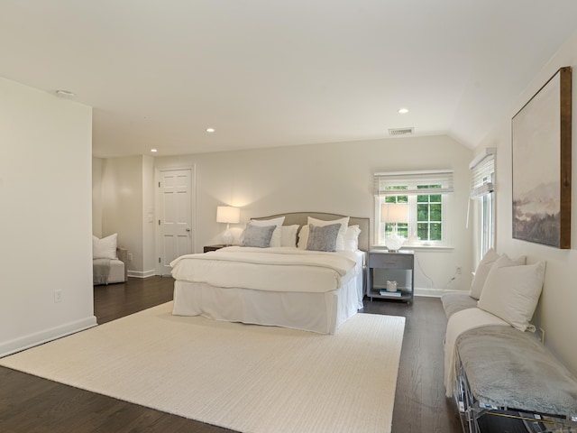 bedroom with dark wood-type flooring and vaulted ceiling