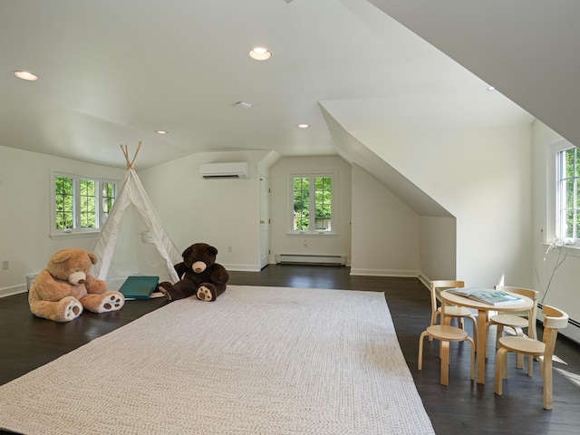 interior space featuring lofted ceiling, dark hardwood / wood-style flooring, a wall mounted air conditioner, and a baseboard heating unit