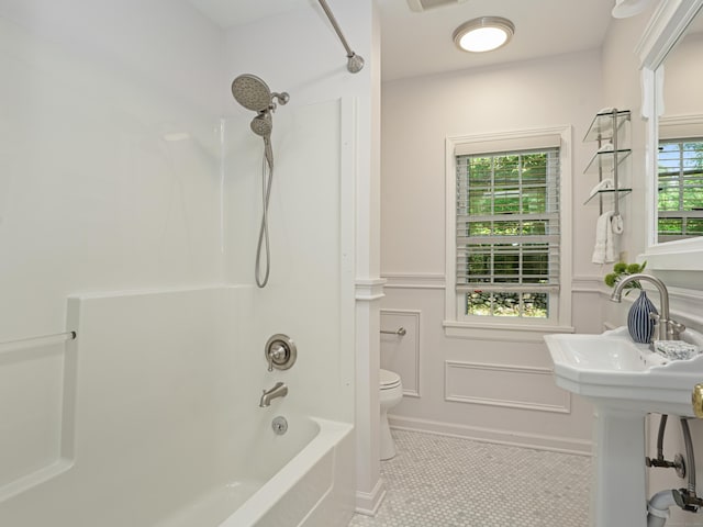 full bathroom with tile patterned flooring, toilet, shower / washtub combination, and sink