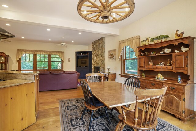 dining area with ceiling fan, light hardwood / wood-style floors, and beam ceiling