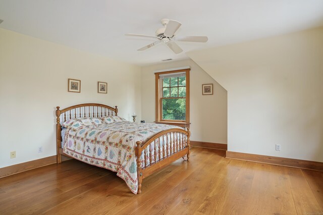 bedroom with ceiling fan and hardwood / wood-style flooring