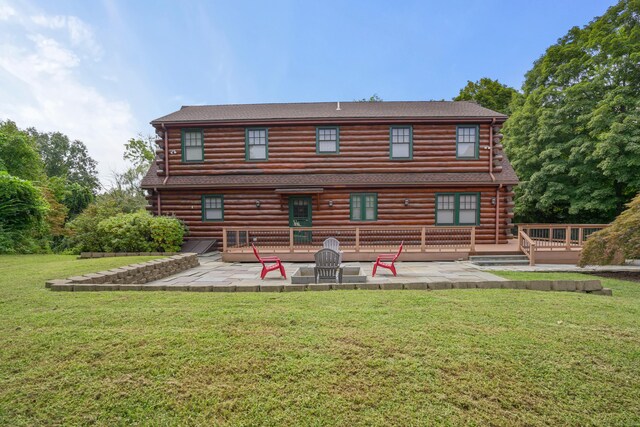 rear view of property with a yard and a patio