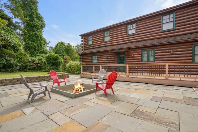 view of patio / terrace with a fire pit and a wooden deck