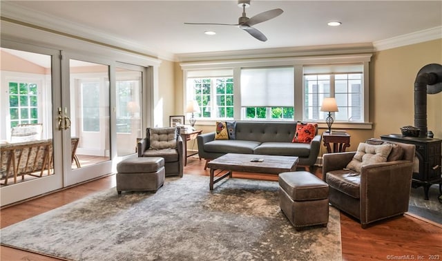 12 W Mountain Rd, Sharon, CT 06069 - living room with a ceiling fan, ornamental molding, wood finished floors, a wood stove, and french doors