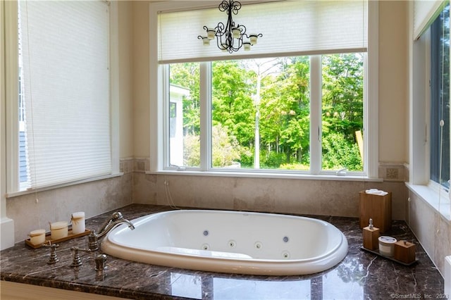 12 W Mountain Rd, Sharon, CT 06069 - bathroom featuring a whirlpool tub and a chandelier