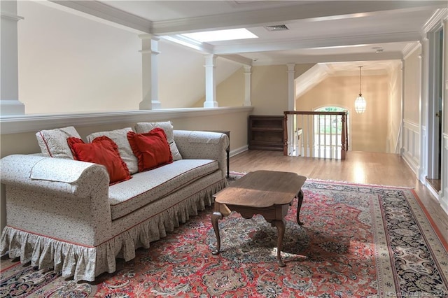 12 W Mountain Rd, Sharon, CT 06069 - living area with vaulted ceiling with beams, wood finished floors, visible vents, decorative columns, and crown molding