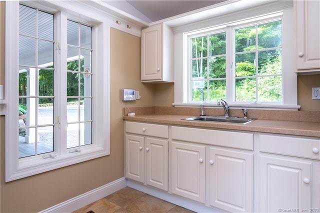 12 W Mountain Rd, Sharon, CT 06069 - kitchen with light tile patterned floors, light countertops, a sink, and white cabinets