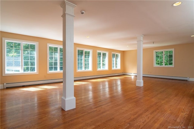 12 W Mountain Rd, Sharon, CT 06069 - unfurnished room with decorative columns, baseboard heating, and wood finished floors