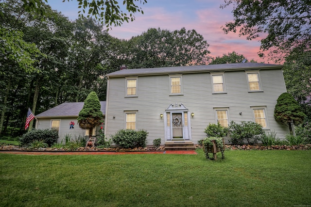 colonial-style house with a lawn