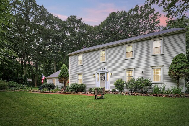 colonial-style house with a lawn