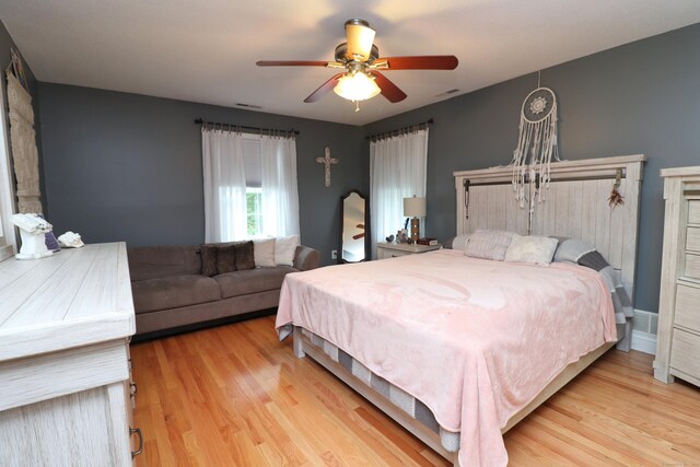 bedroom featuring light wood-type flooring and ceiling fan