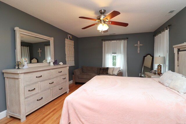 bedroom with ceiling fan and light wood-type flooring