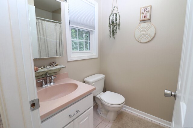 bathroom with tile patterned floors, vanity, and toilet