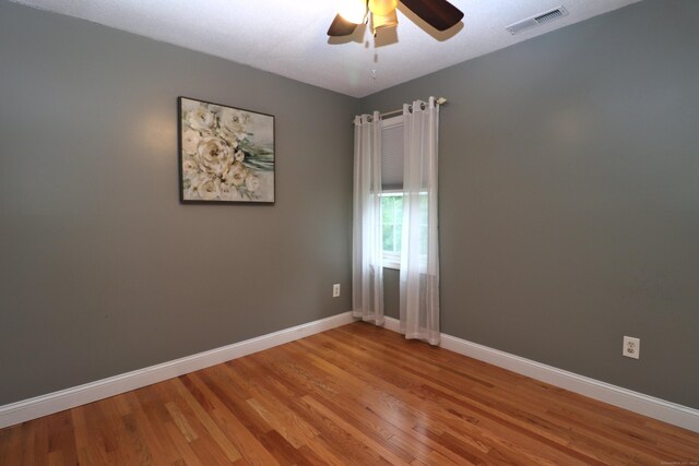 spare room with ceiling fan and light hardwood / wood-style flooring