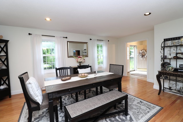 dining area with light wood-type flooring, baseboards, and recessed lighting