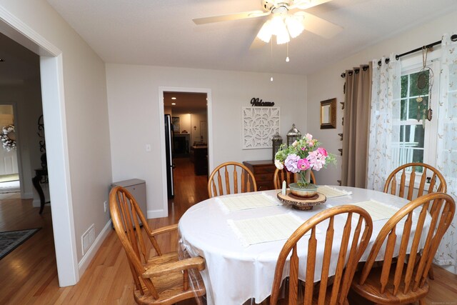 dining room featuring ceiling fan and light hardwood / wood-style floors