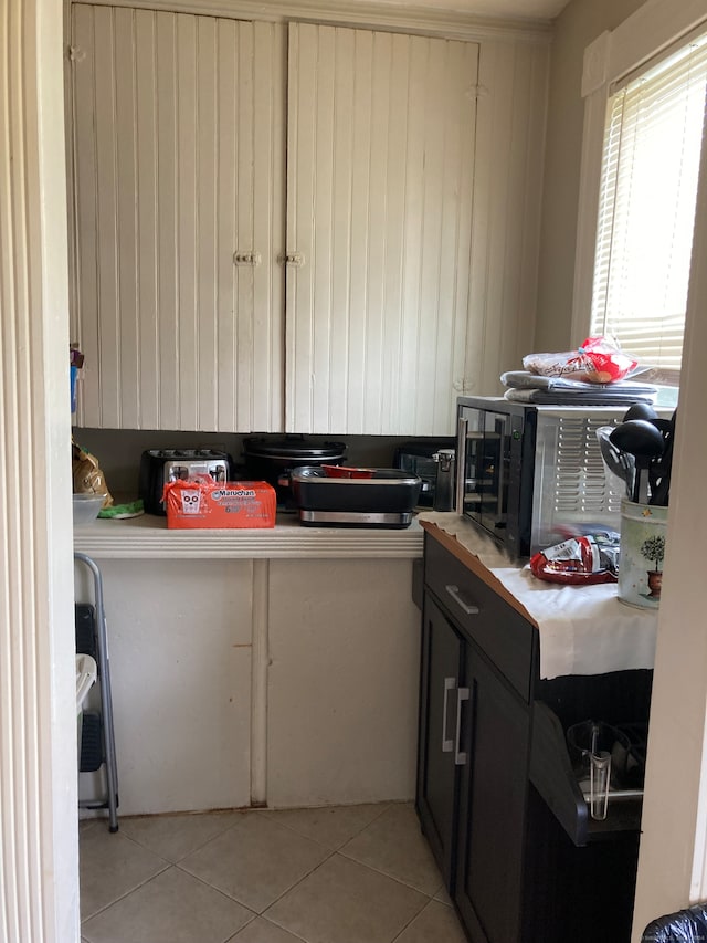 kitchen with light tile patterned flooring