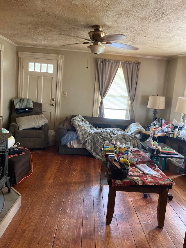 bedroom with dark wood-type flooring, ceiling fan, and a textured ceiling