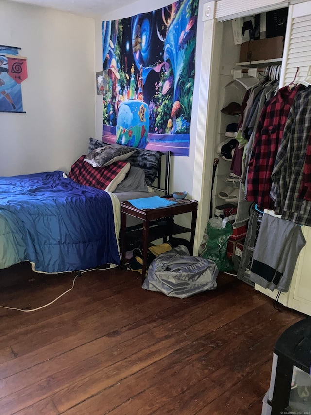 bedroom with a closet and hardwood / wood-style floors