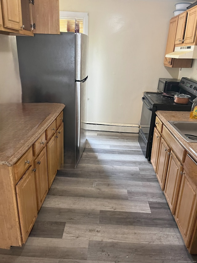 kitchen featuring sink, dark hardwood / wood-style flooring, black appliances, and baseboard heating