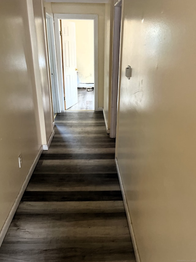 corridor featuring a baseboard radiator and dark hardwood / wood-style flooring