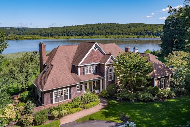 birds eye view of property with a water view