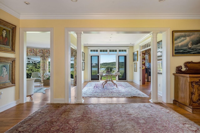 doorway with decorative columns, light hardwood / wood-style flooring, and ornamental molding