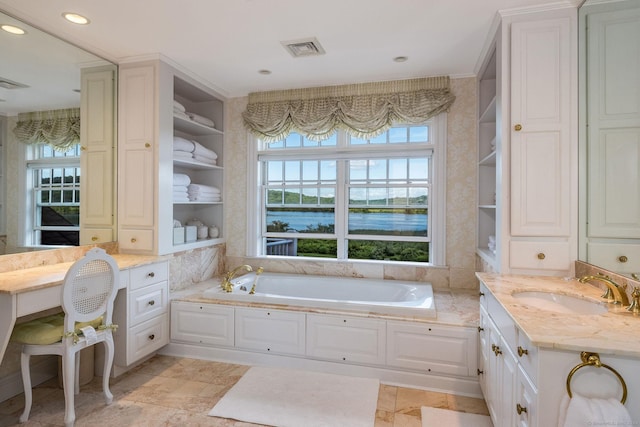 bathroom with a bathtub, a water view, and vanity