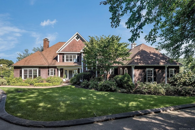 323 River Rd, Deep River, CT 06417 - shingle-style home featuring a chimney, roof with shingles, and a front lawn