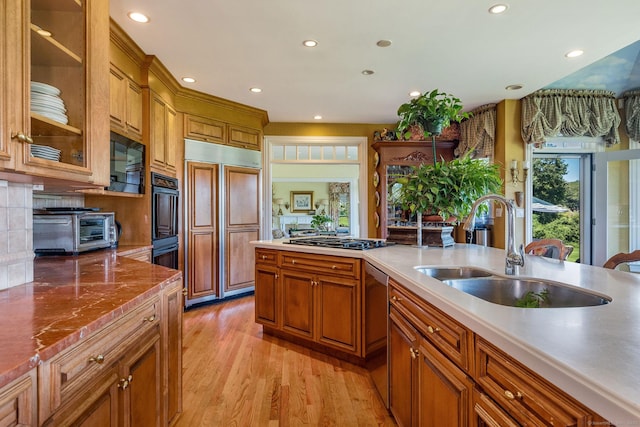 323 River Rd, Deep River, CT 06417 - kitchen with a sink, brown cabinetry, black appliances, and a toaster