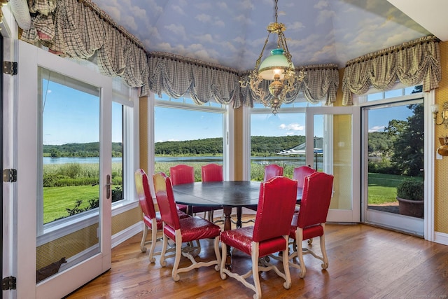 323 River Rd, Deep River, CT 06417 - sunroom featuring an inviting chandelier, a water view, baseboards, and wood finished floors