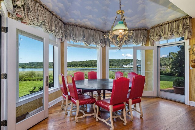 323 River Rd, Deep River, CT 06417 - sunroom / solarium with wood finished floors, a chandelier, and a water view