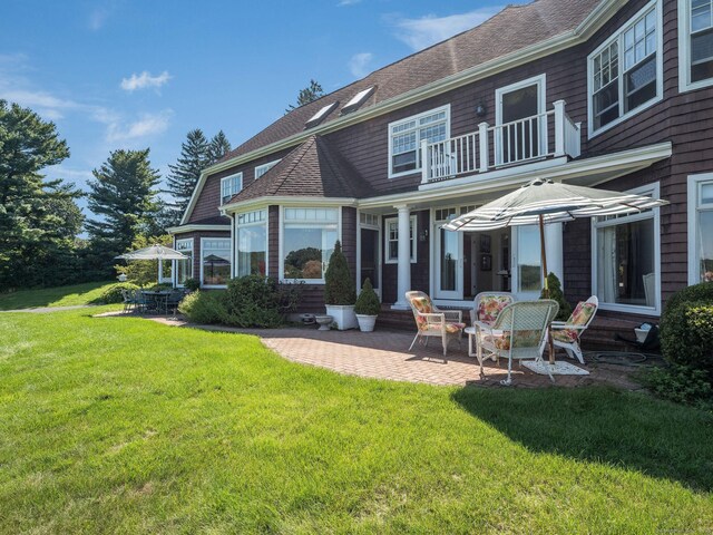 323 River Rd, Deep River, CT 06417 - rear view of house with a balcony, a patio, a yard, and a shingled roof