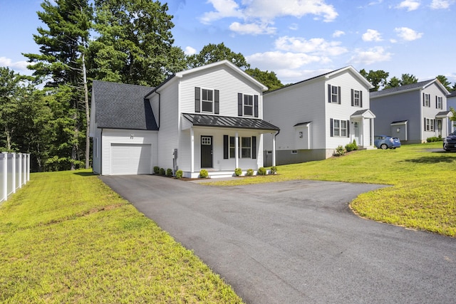 view of front of house featuring a front yard, a porch, and a garage