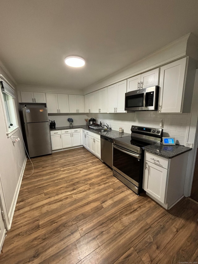 kitchen featuring sink, white cabinetry, hardwood / wood-style flooring, and stainless steel appliances