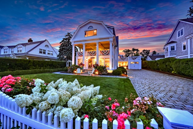 neoclassical / greek revival house with a lawn, covered porch, and an outdoor structure