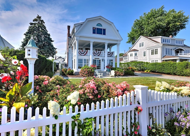 greek revival inspired property featuring a porch