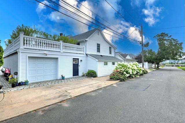 exterior space with a balcony and a garage