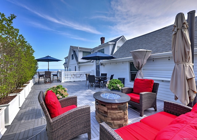 deck with a patio and an outdoor living space with a fire pit